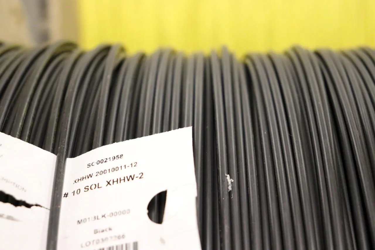 Black XHHW-2 wire on a reel with a label denoting the wire's type. - Photo by Gino Geruntino, KrisTech Wire