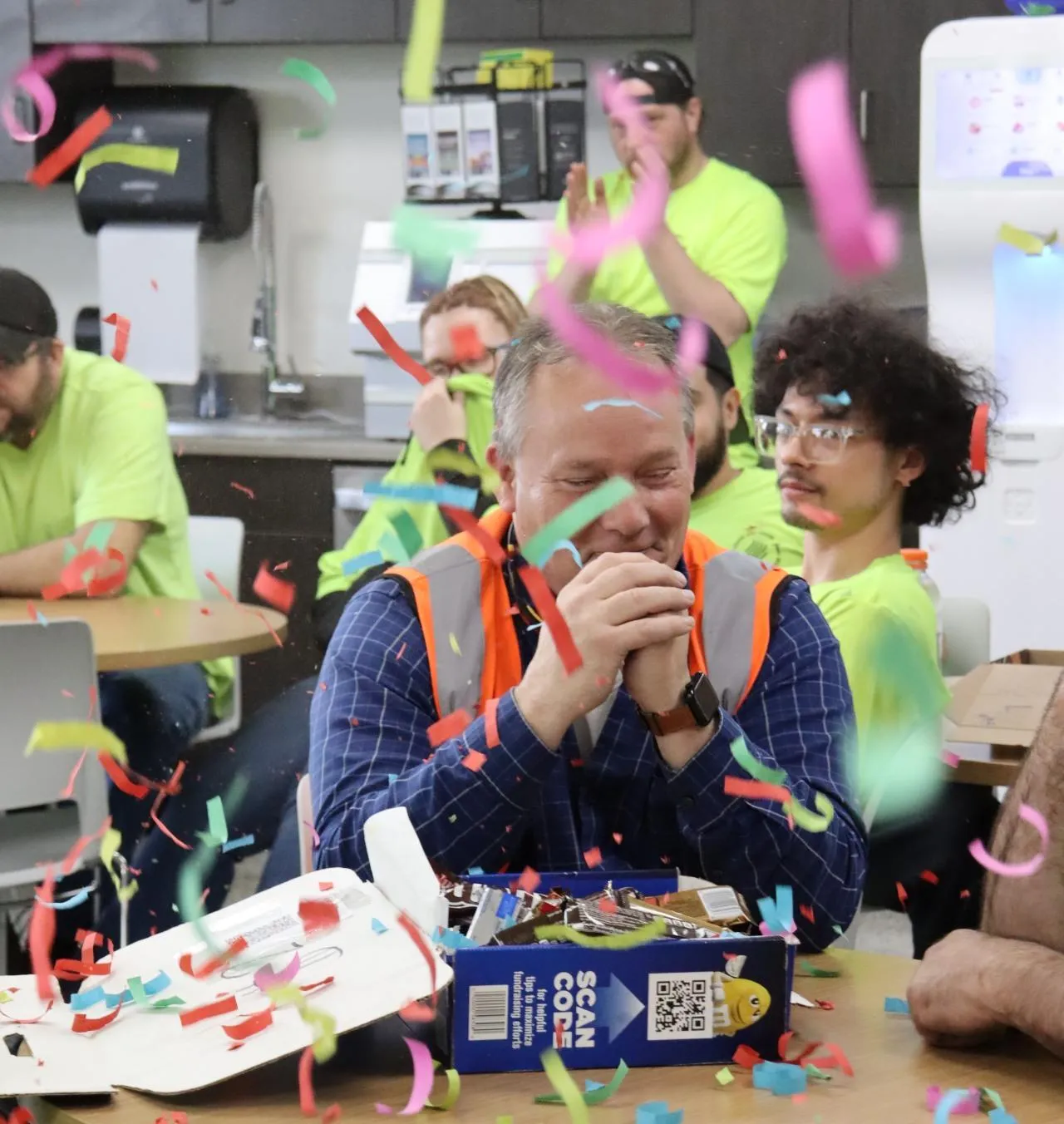 A KrisTech team member is surprised with confetti while being celebrated for winning the company's Employee of the Month award. - KrisTech Wire (Photo via Gino Geruntino)