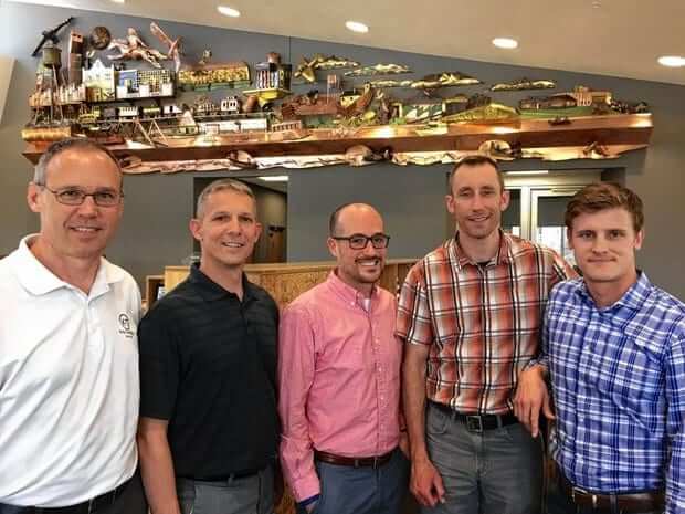 Standing from left are KrisTech team members Bruce Robinson, Steve Pietrowski, Jeff Manzo, Rob Hinsdill and Graham Brodock.