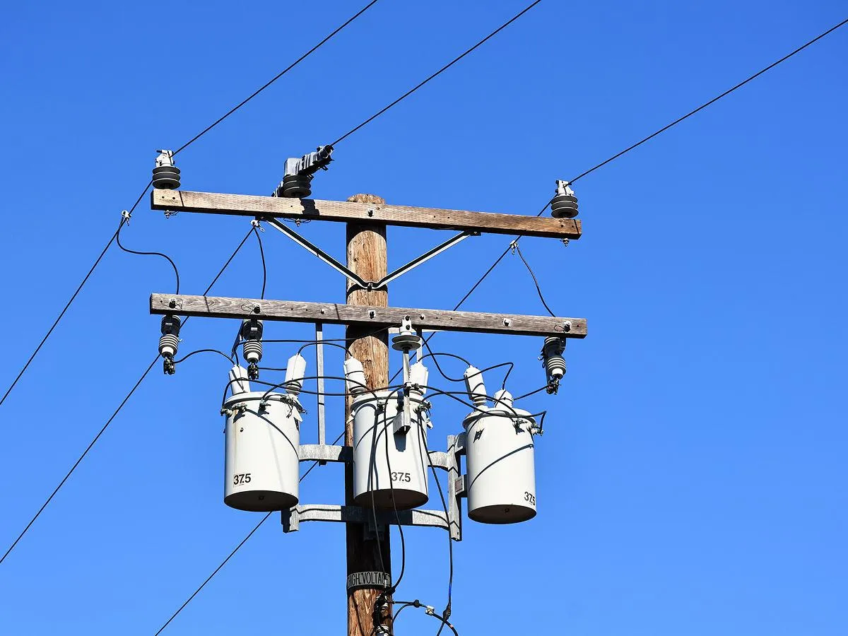 An image of an electrical utility pole on a clear blue day.
