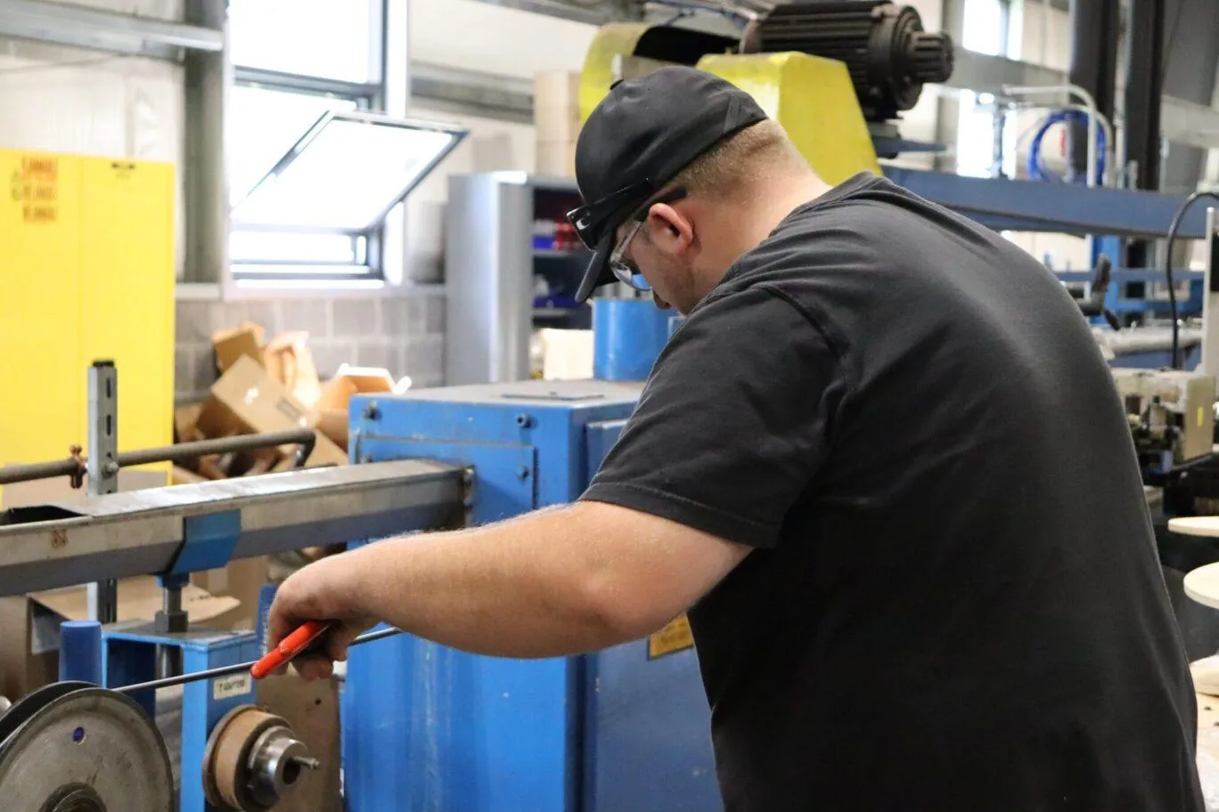 A KrisTech employee makes copper wire in the company's manufacturing facility.