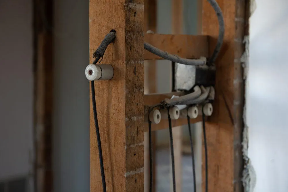 Old knob-and-tube electrical wiring on a job site. KrisTech Wire (Photo via Shutterstock)