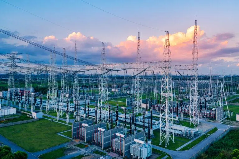 An electrical substation is pictured in front of a multicolored sky. - KrisTech Wire (Photo via Shutterstock)