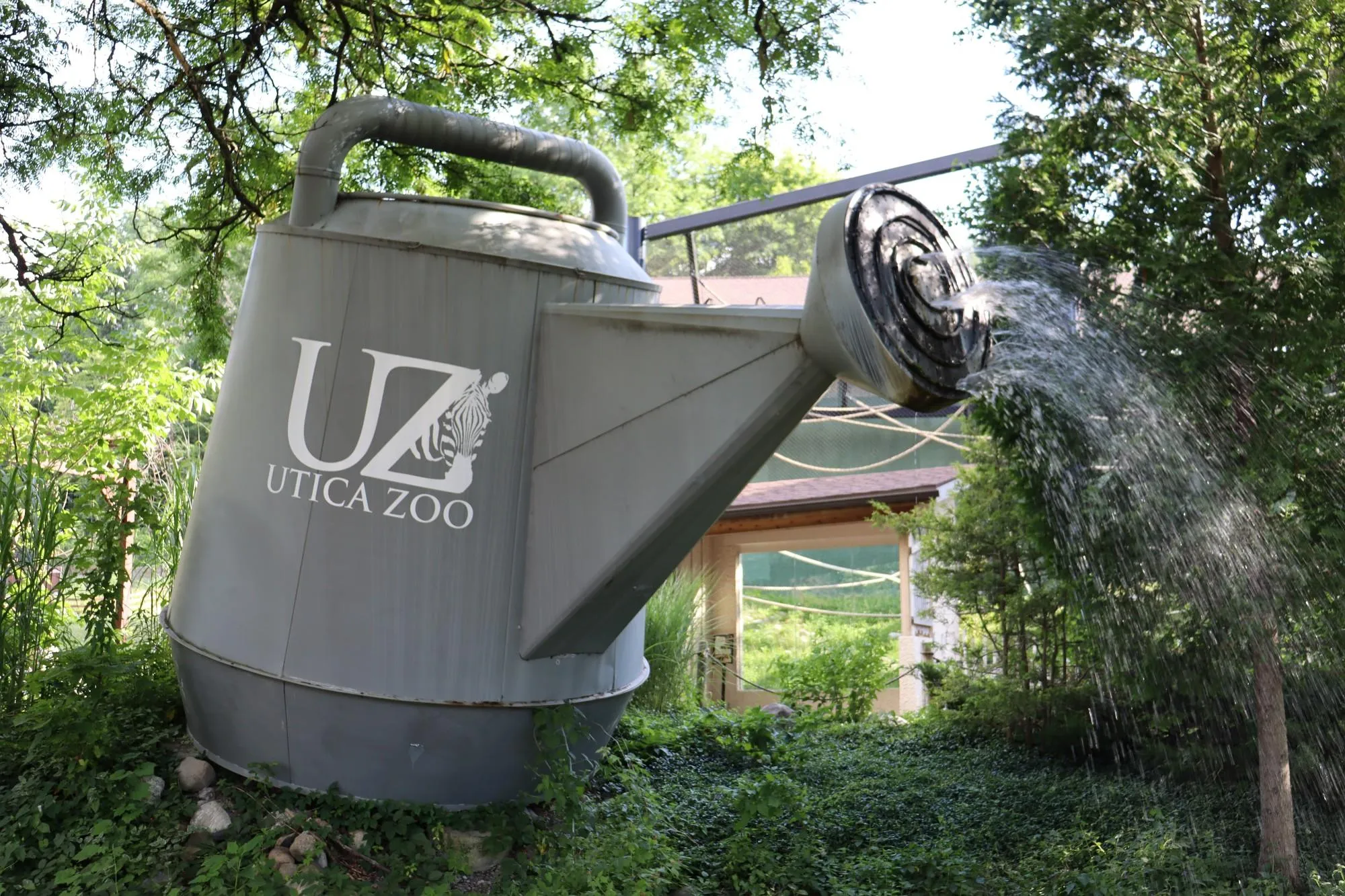 The giant watering can installation on display at the Utica Zoo in Utica, NY. Photo by Gino Geruntino.