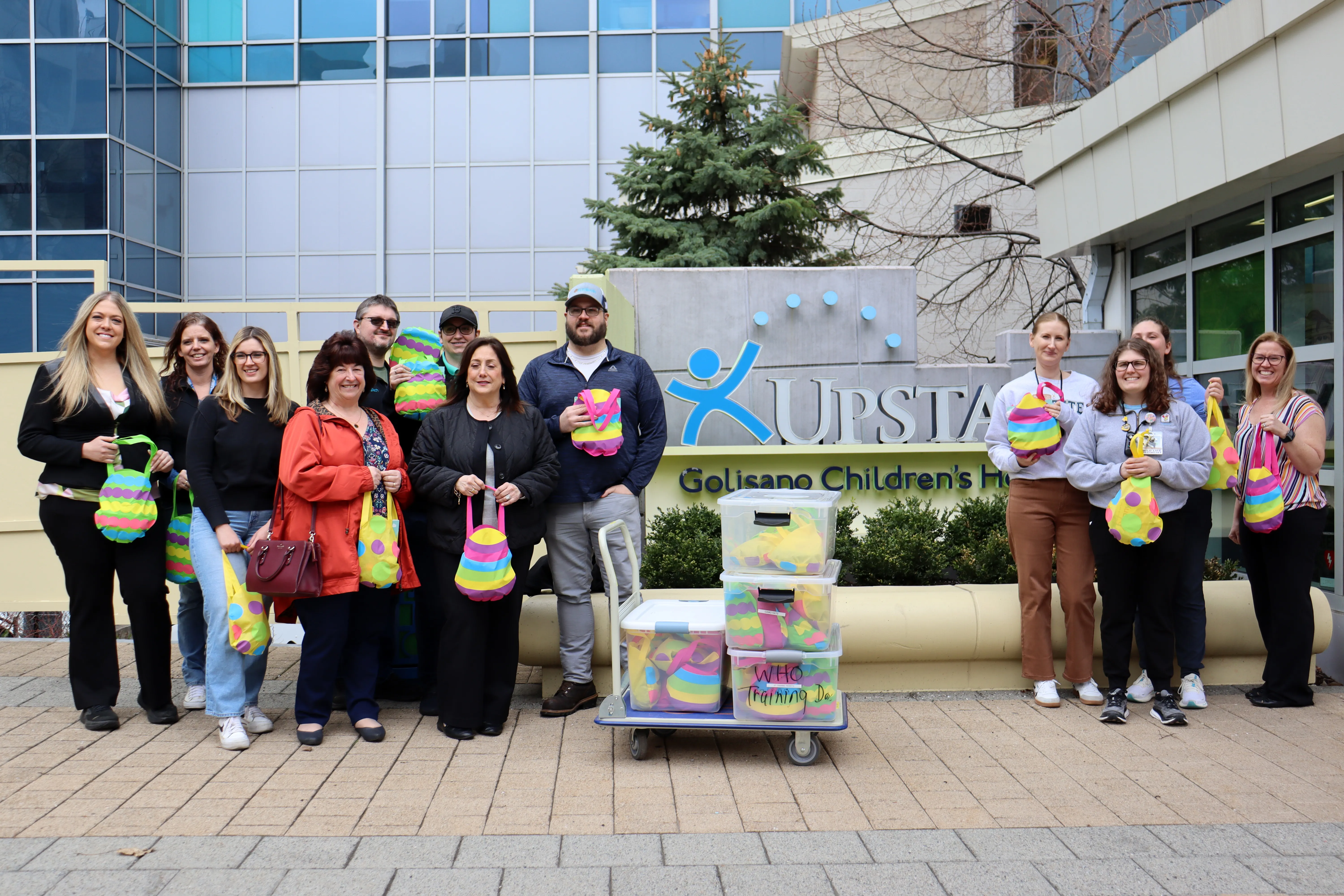 A group of KrisTech Wire employees poses with staff from the Upstate Golisano Children’s Hospital in Syracuse, NY, during an Easter basket drop-off event. Photo by Gino Geruntino.