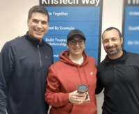 September 2026 KrisTech Employee of the Month Sabrina Livermore poses with her trophy alongside other Finance employees. - KrisTech Wire
