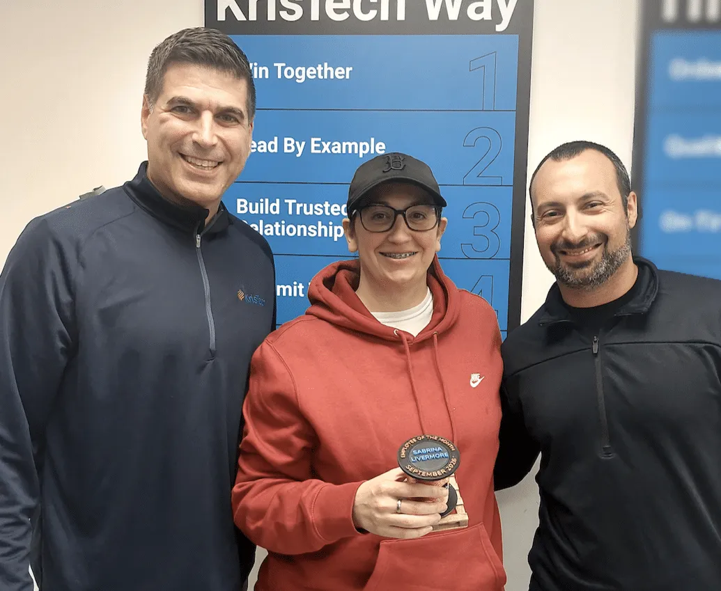 September 2026 KrisTech Employee of the Month Sabrina Livermore poses with her trophy alongside other Finance employees. - KrisTech Wire