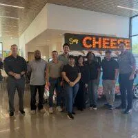 KrisTech volunteers pose for a group photo during a visit to Houston's Kids' Meals facility.